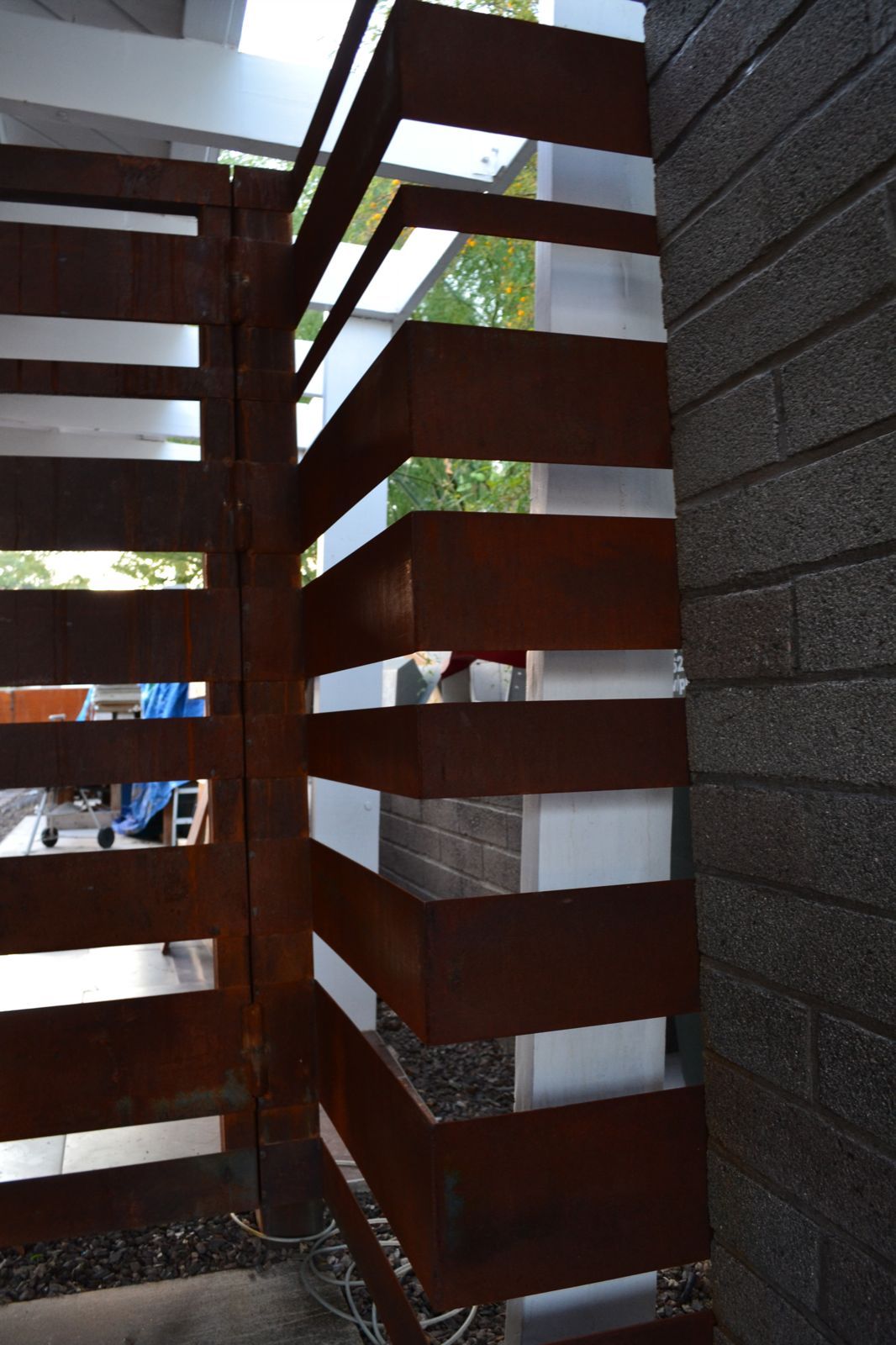 Detail picture of a rusted steel corner detail from a steel gate composition .